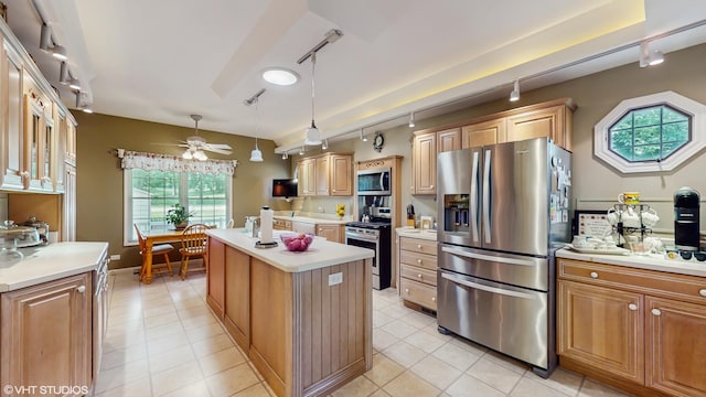 1513 Berwyn St, Spring Grove, IL 60081 - kitchen with track lighting, appliances with stainless steel finishes, light countertops, a center island, and light tile patterned flooring