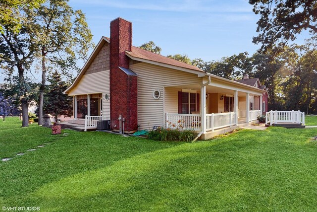 1513 Berwyn St, Spring Grove, IL 60081 - view of side of home featuring covered porch, a chimney, and a yard