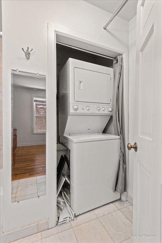 2233 W Shakespeare Ave Unit 1F, Chicago, IL 60647 - laundry room featuring stacked washer / drying machine and light tile patterned floors