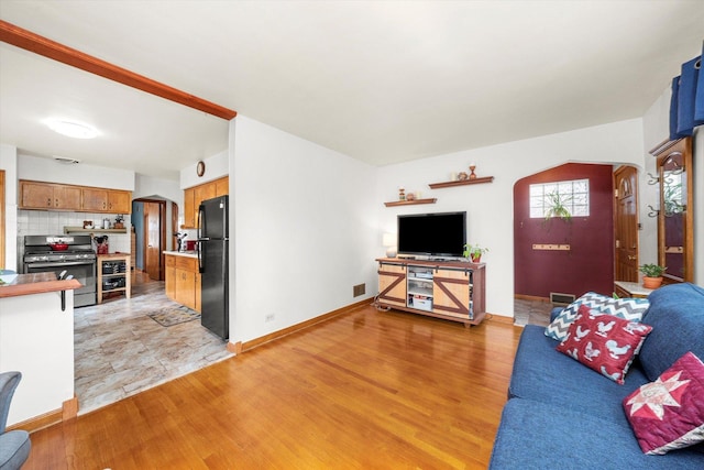 3820 Lombard Ave, Berwyn, IL 60402 - living room featuring arched walkways and light wood-type flooring