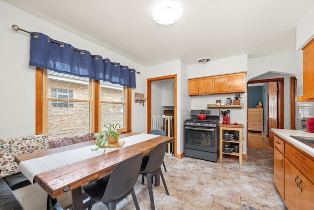3820 Lombard Ave, Berwyn, IL 60402 - dining room featuring arched walkways and light stone finish flooring