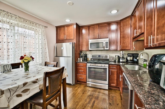 9666 Lois Dr Unit D, Des Plaines, IL 60016 - kitchen with appliances with stainless steel finishes, dark wood-type flooring, dark stone countertops, and recessed lighting