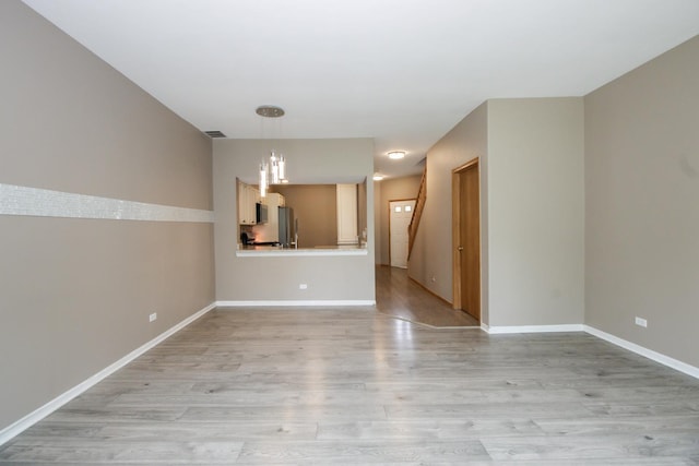 218 Partridge Ct, Algonquin, IL 60102 - unfurnished living room with light wood-style floors and stairs