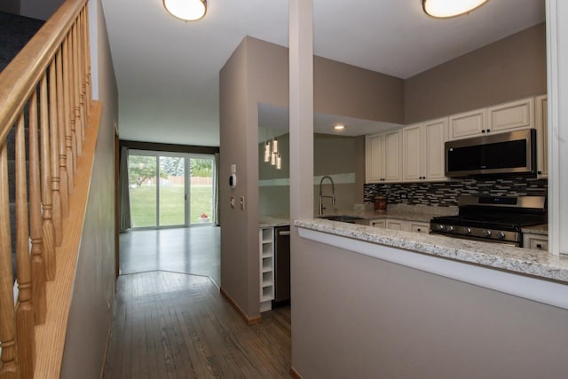 218 Partridge Ct, Algonquin, IL 60102 - kitchen featuring appliances with stainless steel finishes, backsplash, dark wood-type flooring, light stone counters, and white cabinets