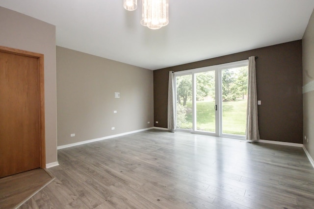 218 Partridge Ct, Algonquin, IL 60102 - spare room featuring a chandelier and light wood-style flooring