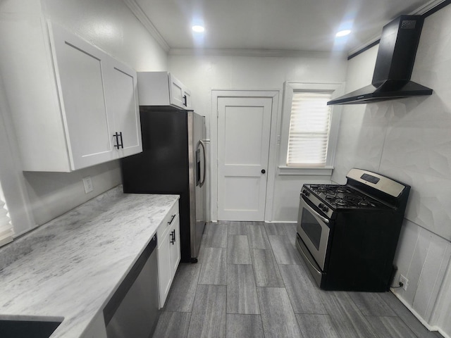 1035 S Osborn Ave, Kankakee, IL 60901 - kitchen featuring appliances with stainless steel finishes, wall chimney range hood, light stone counters, dark wood-style floors, and white cabinets