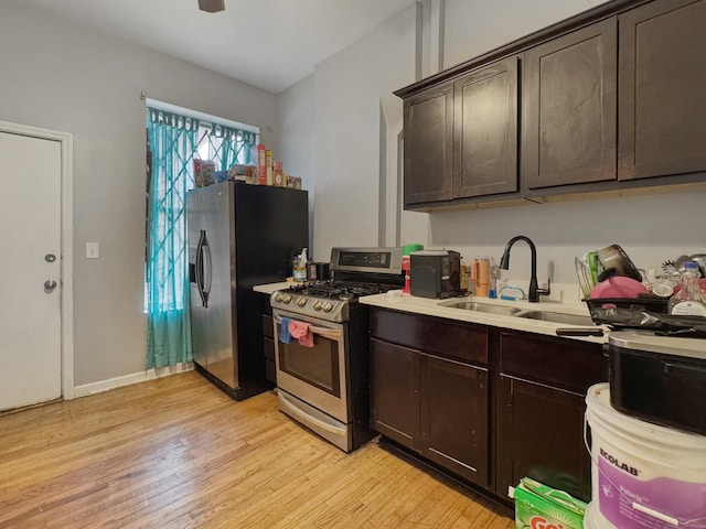 5943 S Indiana Ave, Chicago, IL 60637 - kitchen featuring stainless steel appliances, light wood finished floors, dark brown cabinets, and light countertops