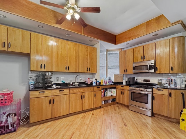 5943 S Indiana Ave, Chicago, IL 60637 - kitchen featuring appliances with stainless steel finishes, dark countertops, tasteful backsplash, and light wood finished floors