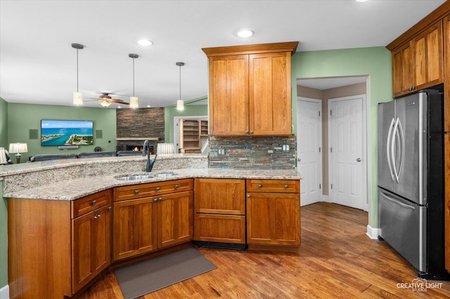24209 Lavergne St, Plainfield, IL 60585 - kitchen with freestanding refrigerator, ceiling fan, a peninsula, brown cabinetry, and recessed lighting