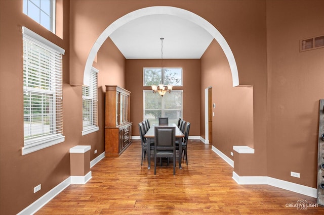 24209 Lavergne St, Plainfield, IL 60585 - dining room with arched walkways, a chandelier, plenty of natural light, and a towering ceiling
