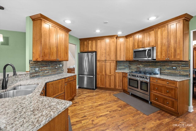 24209 Lavergne St, Plainfield, IL 60585 - kitchen with appliances with stainless steel finishes, tasteful backsplash, wood finished floors, and recessed lighting
