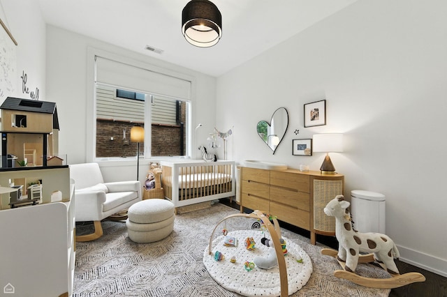 1312 W Madison St Unit 3A, Chicago, IL 60607 - bedroom with a crib and wood finished floors
