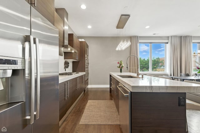 1312 W Madison St Unit 3A, Chicago, IL 60607 - kitchen with stainless steel appliances, modern cabinets, wall chimney exhaust hood, an island with sink, and dark brown cabinetry