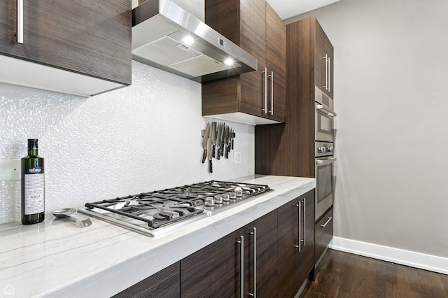 1312 W Madison St Unit 3A, Chicago, IL 60607 - kitchen featuring wall chimney exhaust hood, stainless steel gas stovetop, modern cabinets, dark wood finished floors, and dark brown cabinets