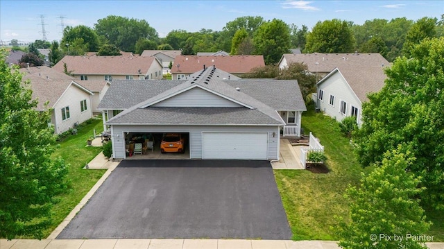 40 S Juniper Dr, North Aurora, IL 60542 - view of front of property with a shingled roof, asphalt driveway, a front lawn, an attached garage, and a residential view