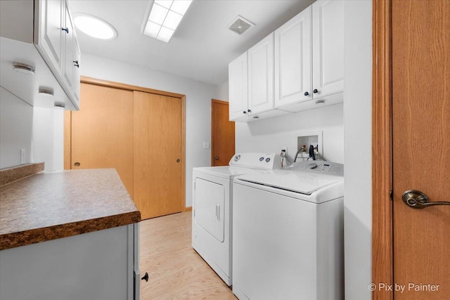 40 S Juniper Dr, North Aurora, IL 60542 - washroom with separate washer and dryer, cabinet space, and light wood-type flooring