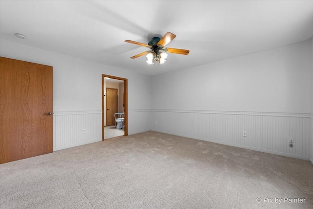 40 S Juniper Dr, North Aurora, IL 60542 - carpeted empty room with a ceiling fan and a wainscoted wall