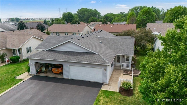 40 S Juniper Dr, North Aurora, IL 60542 - view of front facade with roof with shingles, driveway, a garage, a residential view, and a front yard