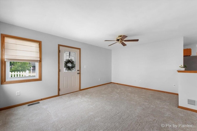 40 S Juniper Dr, North Aurora, IL 60542 - unfurnished living room featuring carpet and ceiling fan