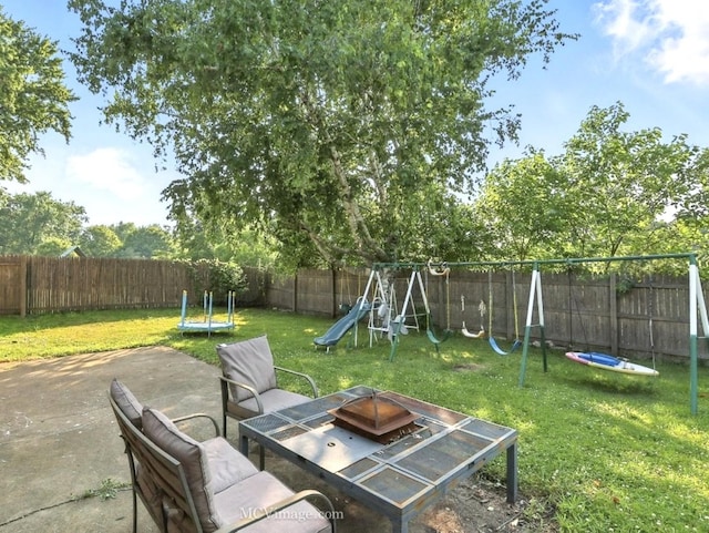 216 Cheshire Ct, Bolingbrook, IL 60440 - fenced backyard featuring a playground, a patio, a fire pit, and a trampoline