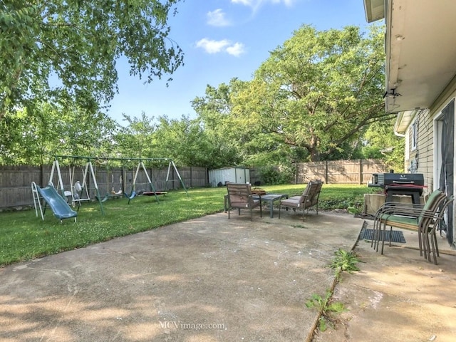 216 Cheshire Ct, Bolingbrook, IL 60440 - fenced backyard with a playground, a storage shed, a patio area, and grilling area