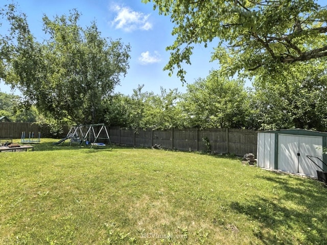 216 Cheshire Ct, Bolingbrook, IL 60440 - fenced backyard with a storage shed and a playground
