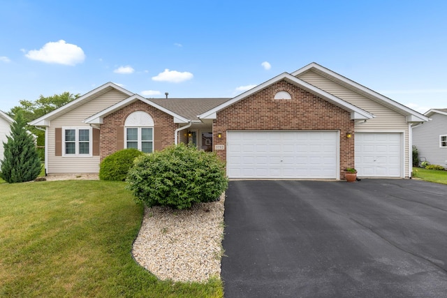 3792 Foxglove Ln, Winnebago, IL 61088 - single story home with driveway, an attached garage, brick siding, and a front yard