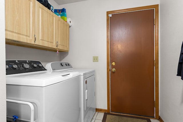 3792 Foxglove Ln, Winnebago, IL 61088 - laundry area featuring washing machine and clothes dryer, cabinet space, and light tile patterned floors