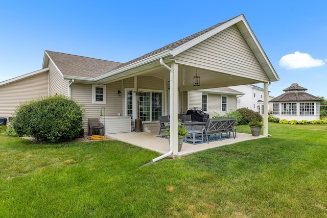 3792 Foxglove Ln, Winnebago, IL 61088 - rear view of property with a patio, a lawn, and a shingled roof