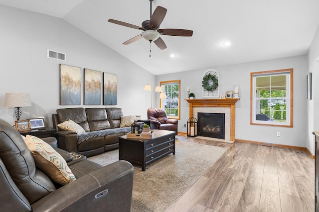 3792 Foxglove Ln, Winnebago, IL 61088 - living area with light wood finished floors, plenty of natural light, vaulted ceiling, a ceiling fan, and a tile fireplace