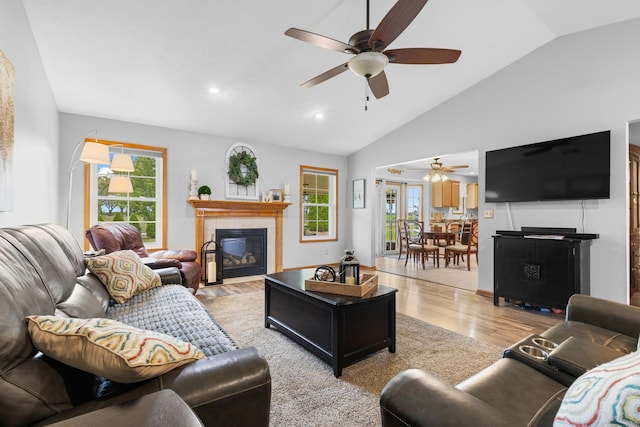 3792 Foxglove Ln, Winnebago, IL 61088 - living area with a ceiling fan, a tile fireplace, lofted ceiling, healthy amount of natural light, and light wood-type flooring