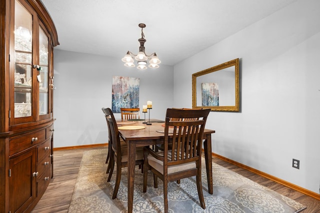 3792 Foxglove Ln, Winnebago, IL 61088 - dining room featuring wood finished floors and a chandelier