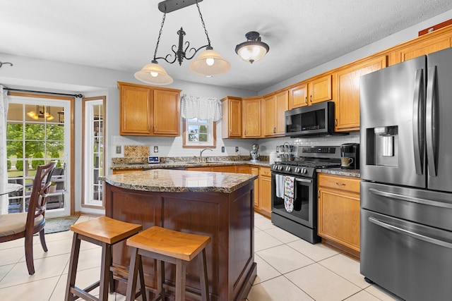 3792 Foxglove Ln, Winnebago, IL 61088 - kitchen with appliances with stainless steel finishes, light tile patterned flooring, healthy amount of natural light, and a center island