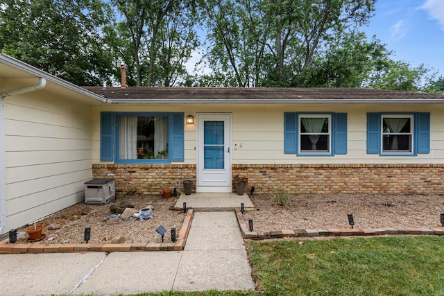 2305 Glenoak Dr, Champaign, IL 61821 - view of exterior entry featuring brick siding and a shingled roof