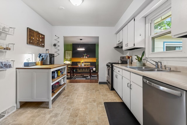 2305 Glenoak Dr, Champaign, IL 61821 - kitchen featuring appliances with stainless steel finishes, white cabinetry, under cabinet range hood, and decorative light fixtures