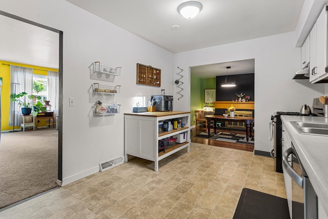 2305 Glenoak Dr, Champaign, IL 61821 - kitchen featuring stainless steel appliances, white cabinetry, light countertops, under cabinet range hood, and decorative light fixtures