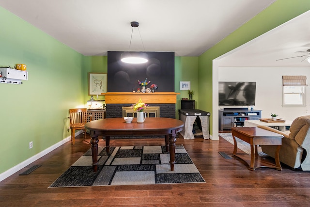 2305 Glenoak Dr, Champaign, IL 61821 - dining room with a fireplace, a ceiling fan, and wood finished floors