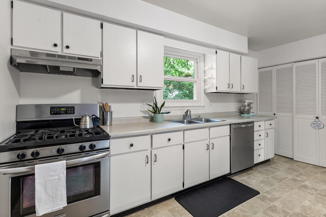 2305 Glenoak Dr, Champaign, IL 61821 - kitchen featuring appliances with stainless steel finishes, under cabinet range hood, light countertops, and white cabinetry