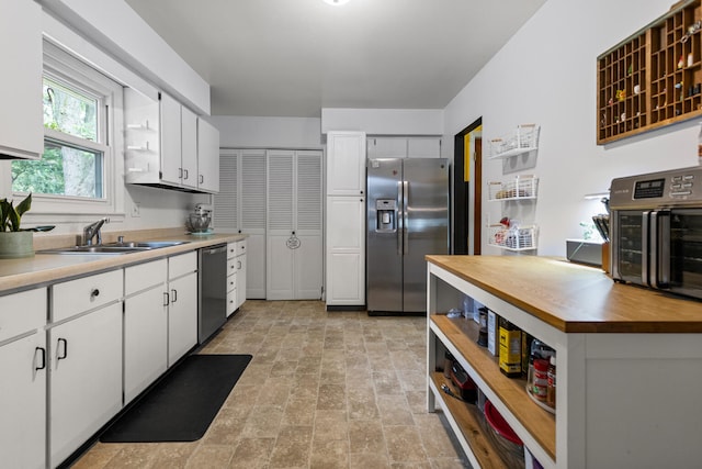 2305 Glenoak Dr, Champaign, IL 61821 - kitchen featuring appliances with stainless steel finishes, open shelves, butcher block counters, and white cabinetry