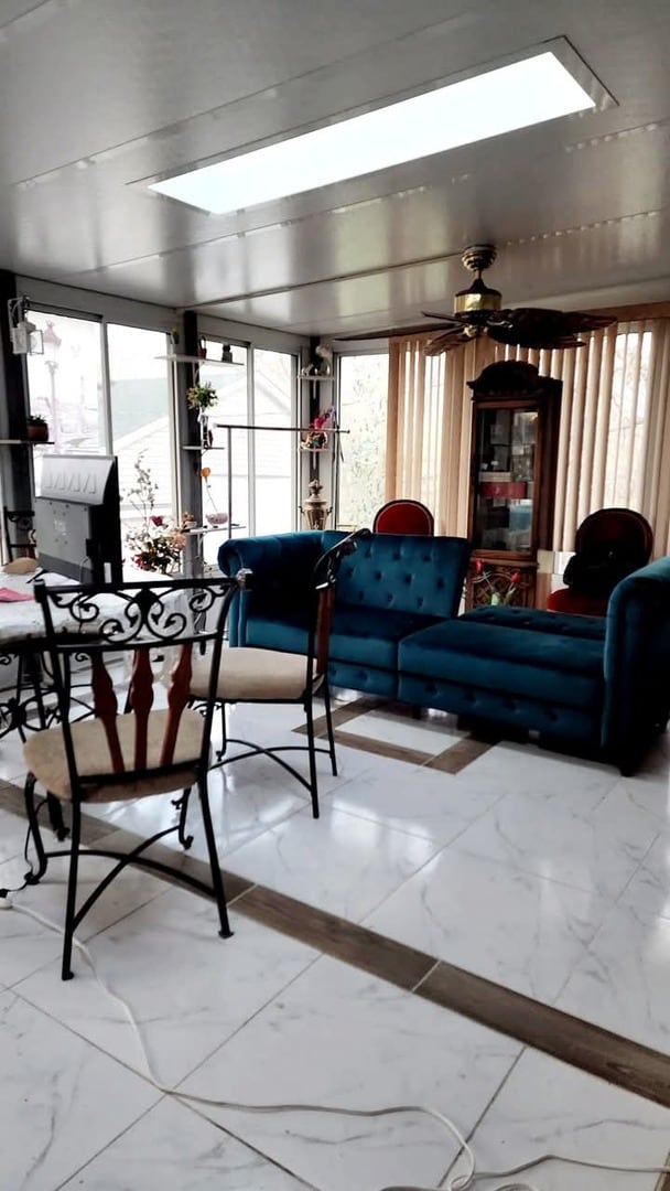 94 E Lakeview Ave, Round Lake Beach, IL 60073 - living room with marble finish floors and a skylight