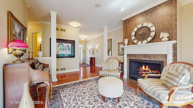 870 Legacy Rdg, Algonquin, IL 60102 - living room featuring wood finished floors, a tile fireplace, ornamental molding, and decorative columns