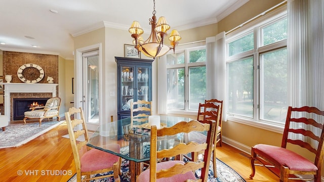 870 Legacy Rdg, Algonquin, IL 60102 - dining space featuring plenty of natural light, a chandelier, wood finished floors, ornamental molding, and a fireplace