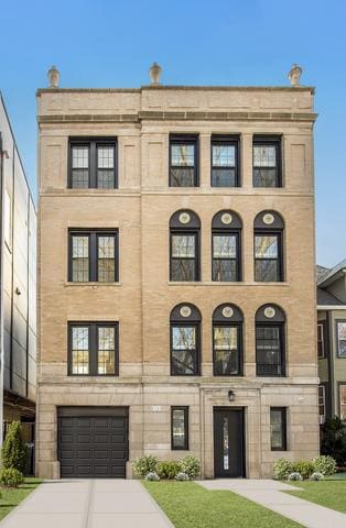 1535 W Estes Ave Unit 4, Chicago, IL 60626 - view of building exterior with concrete driveway and a garage