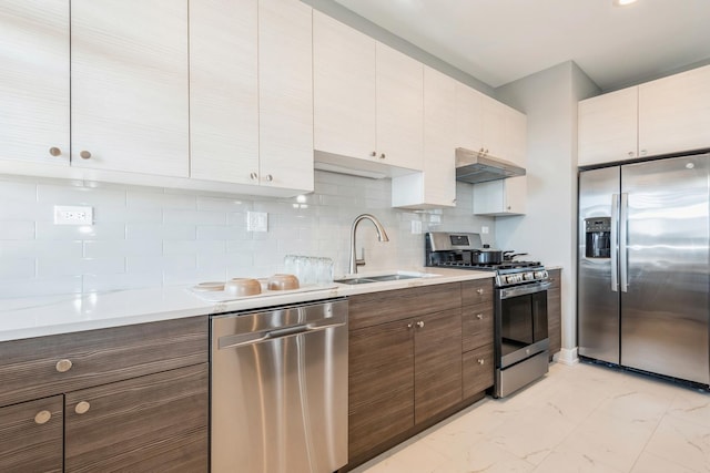 1535 W Estes Ave Unit 4, Chicago, IL 60626 - kitchen featuring stainless steel appliances, under cabinet range hood, light marble finish floors, and light countertops