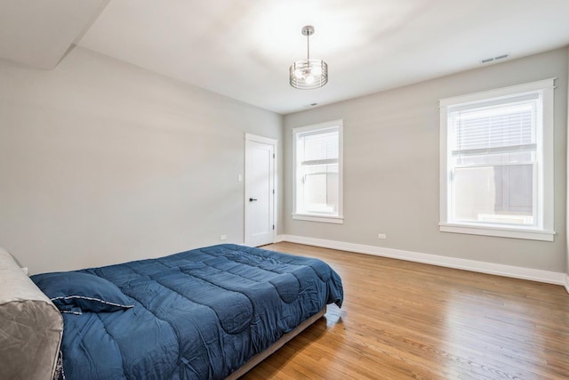 1535 W Estes Ave Unit 4, Chicago, IL 60626 - bedroom with wood finished floors and a chandelier