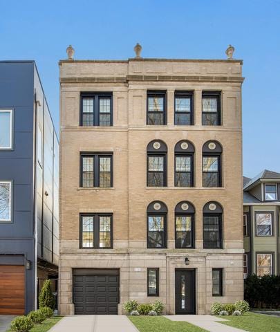 1535 W Estes Ave Unit 4, Chicago, IL 60626 - view of front of property with concrete driveway, stone siding, and a garage