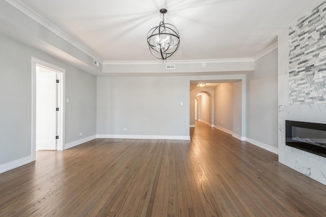 1535 W Estes Ave Unit 4, Chicago, IL 60626 - unfurnished living room with arched walkways, dark wood-type flooring, a chandelier, crown molding, and a large fireplace