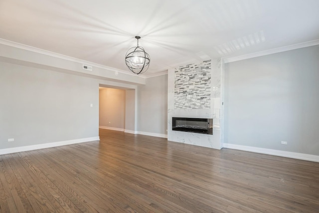 1535 W Estes Ave Unit 4, Chicago, IL 60626 - unfurnished living room with ornamental molding, a chandelier, wood finished floors, and a fireplace