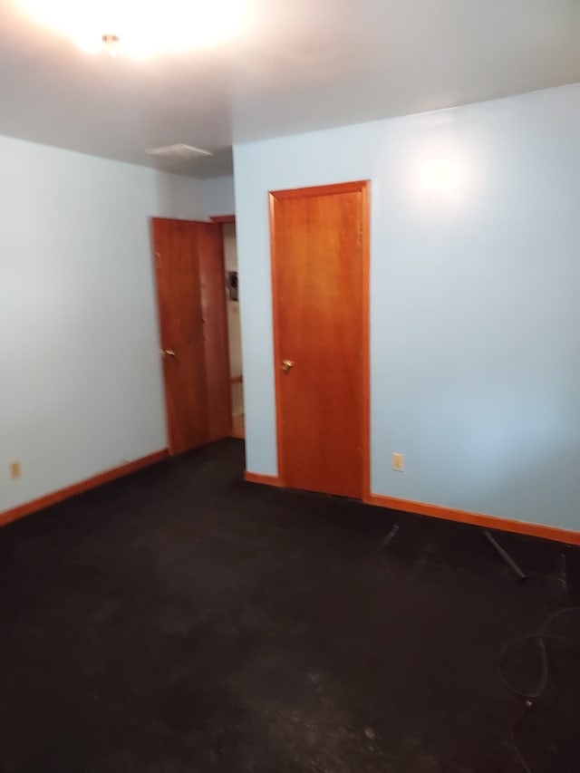 501 S Spruce St, Villa Grove, IL 61956 - unfurnished room with baseboards and dark carpet