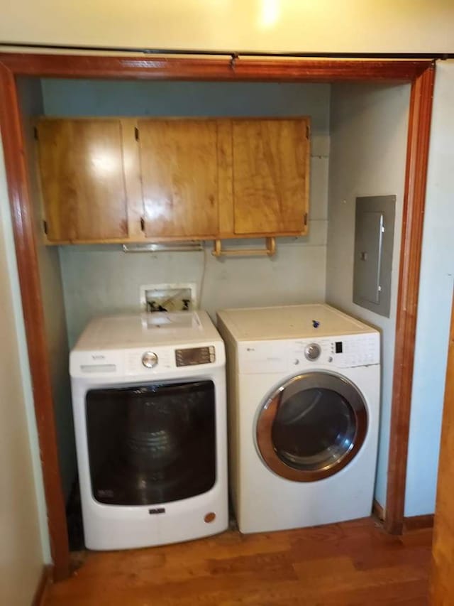 501 S Spruce St, Villa Grove, IL 61956 - washroom with cabinet space, washer and clothes dryer, wood finished floors, and electric panel